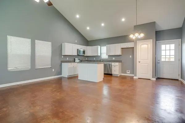 a large kitchen with kitchen island a sink stainless steel appliances and cabinets