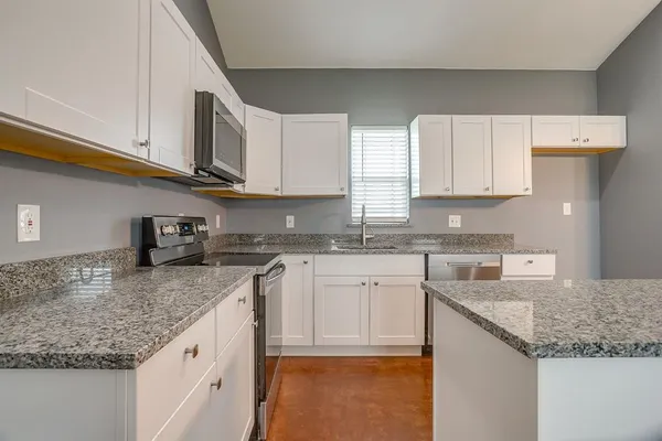 a view of a kitchen with a sink and a refrigerator