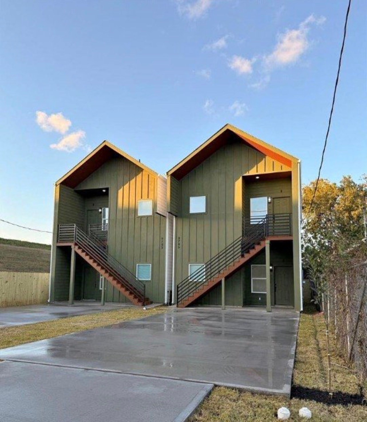 a front view of a house with wooden stairs
