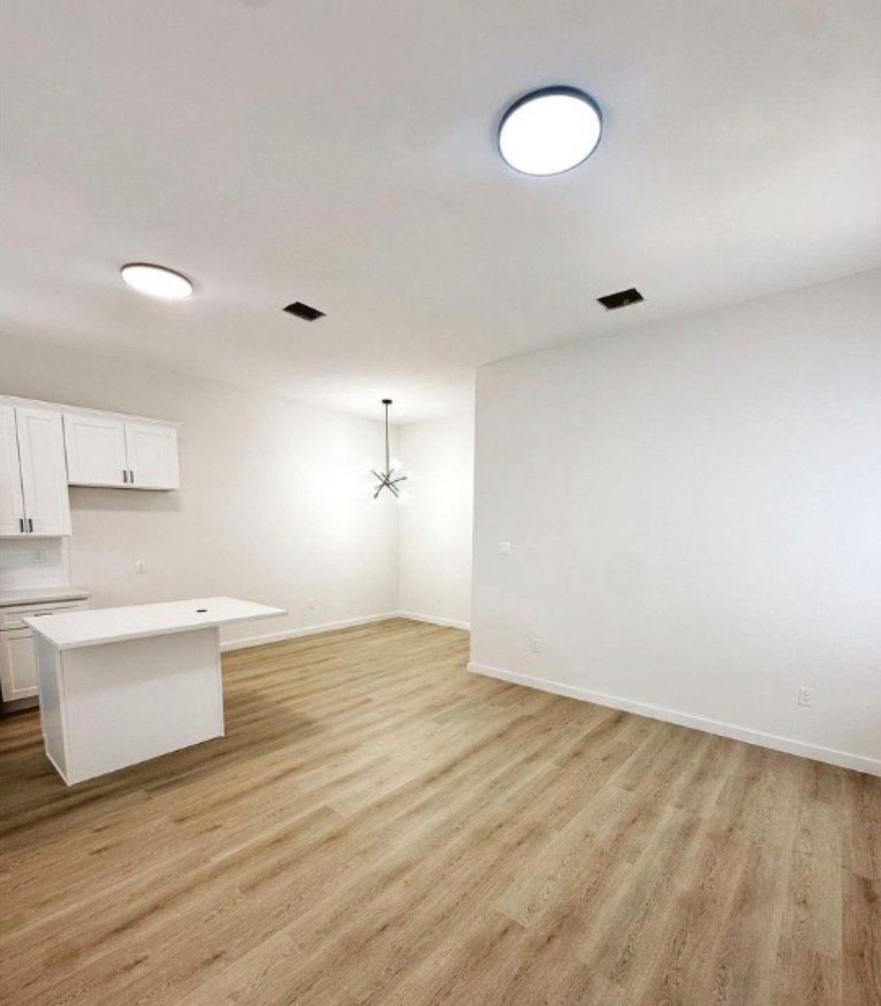 9705 Garcroft Street, Unit A Houston, TX 77029 - Photo 5 of 12 an empty room with wooden floor and windows