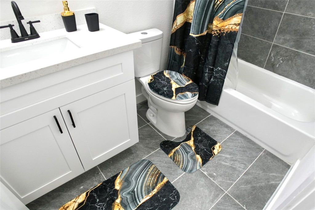 9705 Garcroft Street, Unit A Houston, TX 77029 - Photo 7 of 12 a bathroom with a sink and mirror with toilet