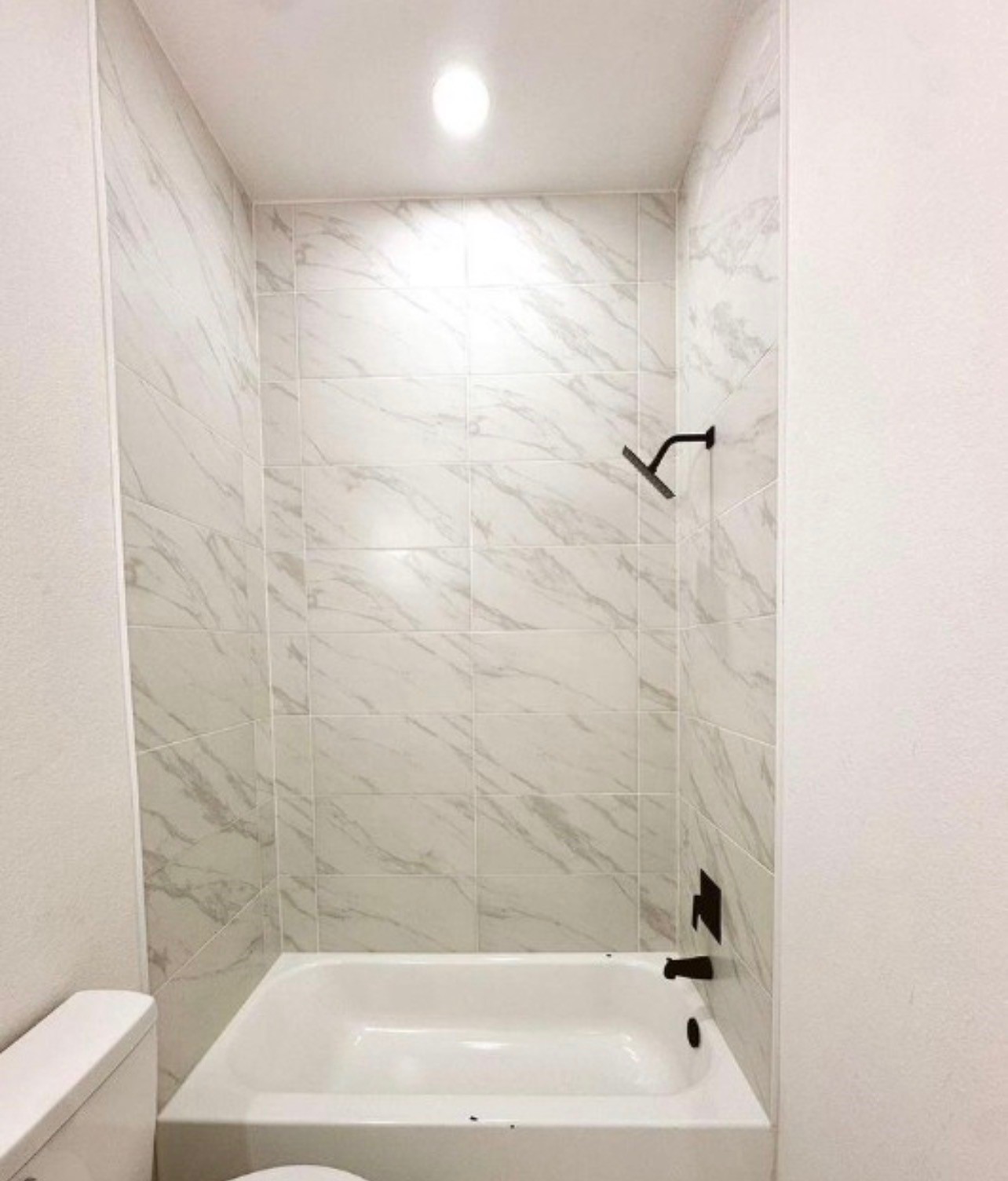 9705 Garcroft Street, Unit A Houston, TX 77029 - Photo 9 of 12 a bathroom with a bathtub