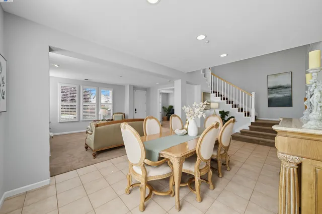 a dining room with furniture and a clock