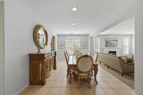 a dining room with furniture and a clock