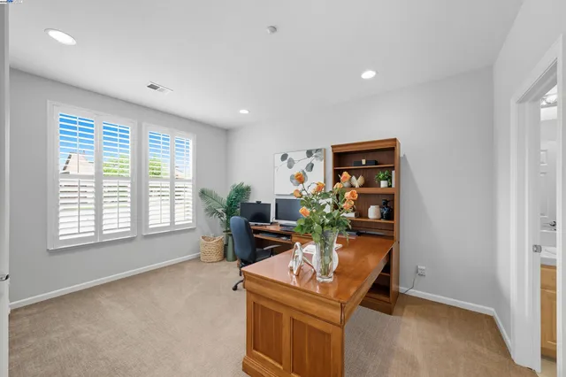 a kitchen with a dining table chairs and white appliances