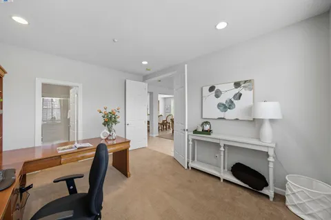 a kitchen with a dining table chairs and white appliances
