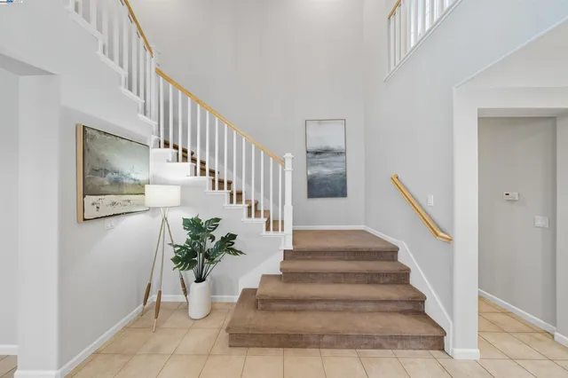 a kitchen with granite countertop a sink window and cabinets