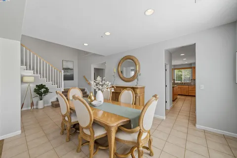 a kitchen with granite countertop a sink a stove a counter space and cabinets