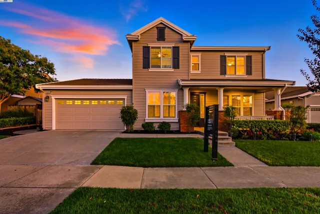 a front view of a house with a yard and porch