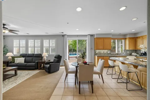 a kitchen with stainless steel appliances granite countertop a sink a stove cabinets and granite counter tops