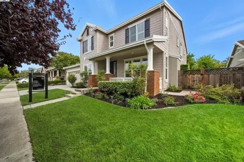 a front view of a house with a yard and porch