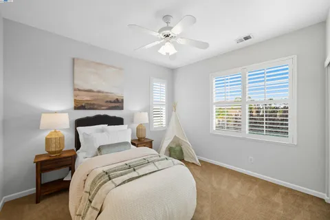 a bedroom with bed and a chandelier