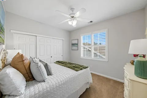 a bathroom with a shower curtain and a window