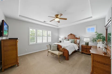 a bathroom with a granite countertop sink mirror and bathtub