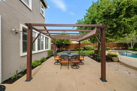 a view of a swimming pool with lounge chairs in the patio