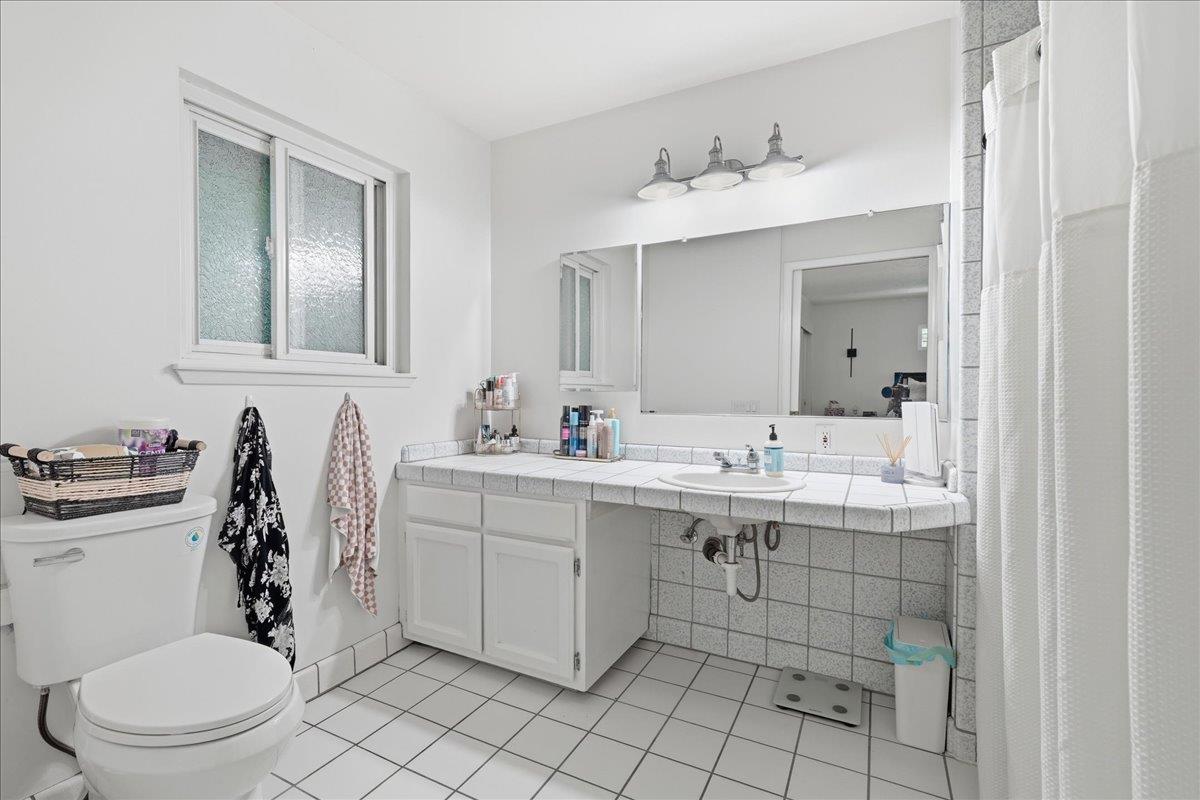 4849 Alexon Way Carmichael, CA 95608 - Photo 35 of 50 a bathroom with a toilet sink and mirror