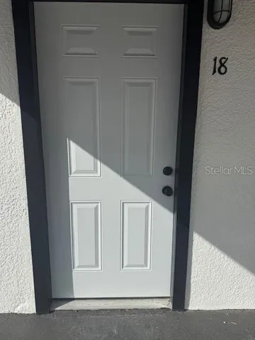 a view of a kitchen with a refrigerator a microwave and a ceiling fan
