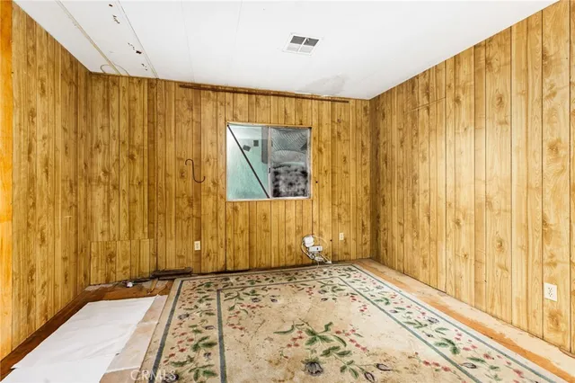 a bathroom with a shower curtain and a chair