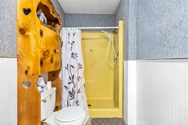 a bathroom with a toilet and shower