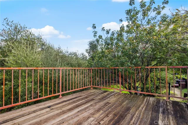 a view of a back yard with a wooden fence