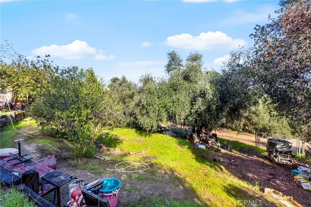 a view of backyard with table and chairs and potted plants