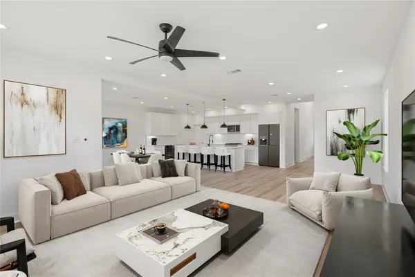 a living room with furniture and a chandelier