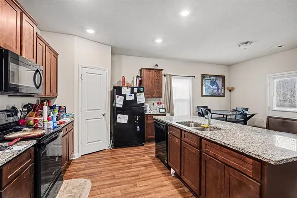 a kitchen with refrigerator and cabinets