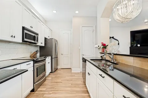 a kitchen with stainless steel appliances a sink stove and refrigerator
