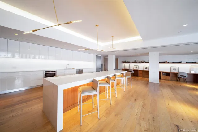 a kitchen with stainless steel appliances granite countertop a sink dishwasher and a stove with wooden floor