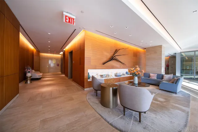 a lobby with furniture and floor to ceiling window