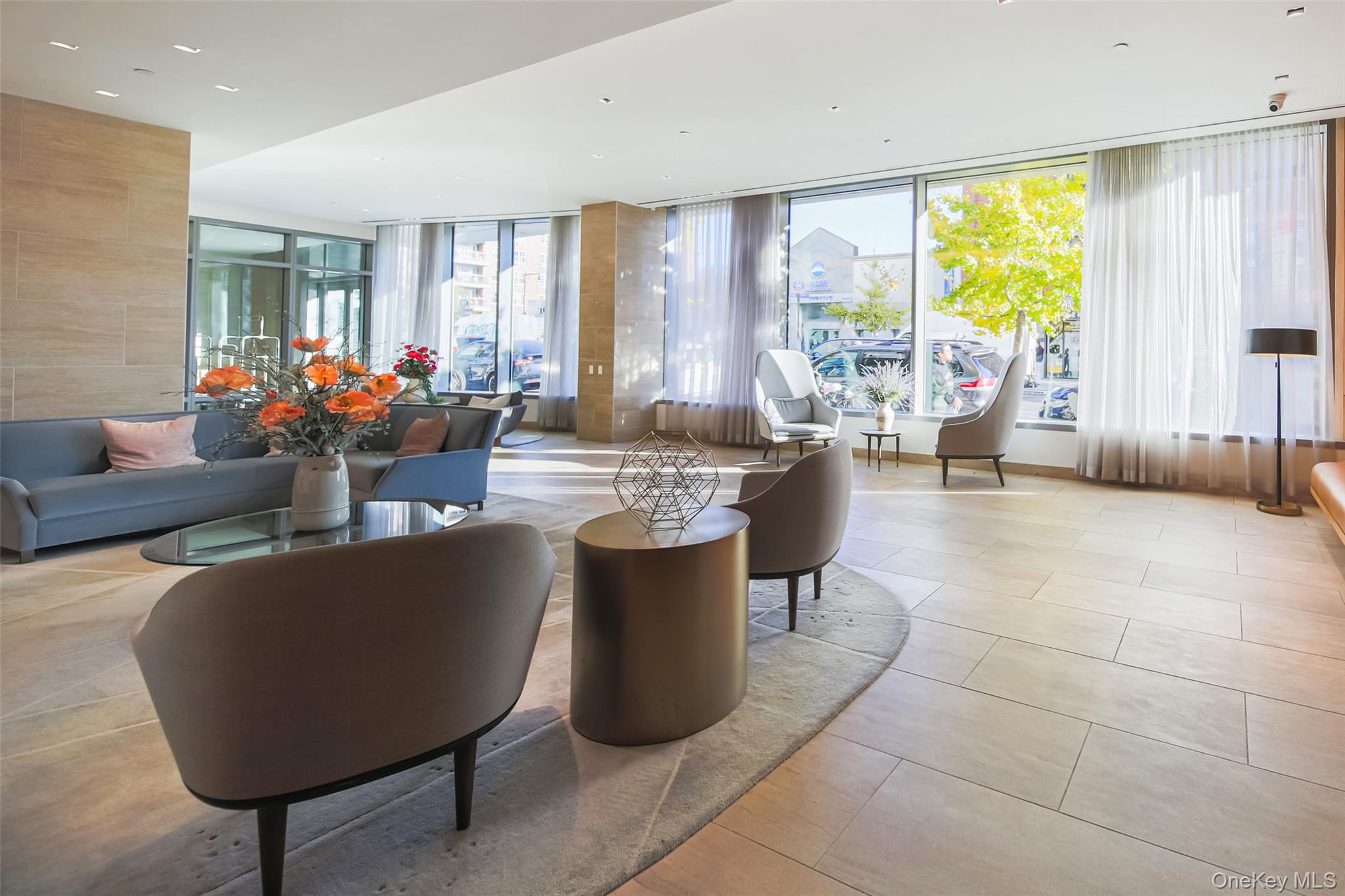 138-35 39th Avenue, Unit 17H Queens, NY 11354 - Photo 31 of 36 a living room with couches a coffee table and a potted plant with wooden floor