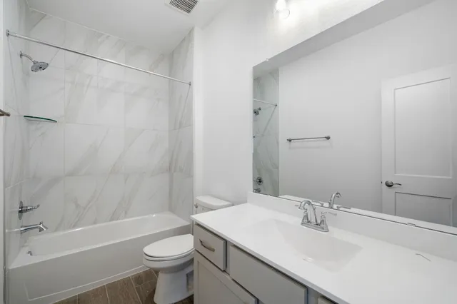 an aerial view of a house with garden space and street view