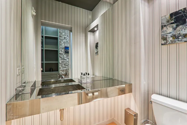 a spacious bathroom with a sink a mirror and vanity