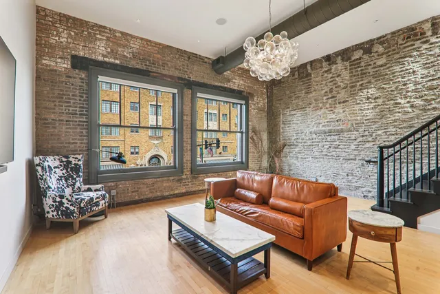a roof deck with couches and wooden floor