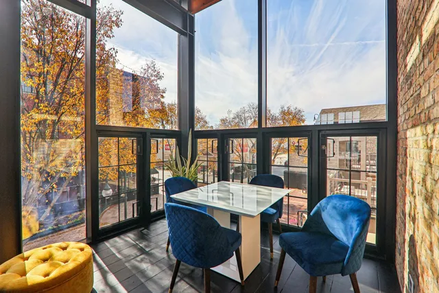 a view of a city from a dining room with furniture window and outside view