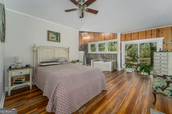 a bedroom with a bed and a large window
