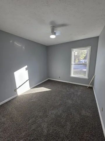 an empty room with windows and entrance