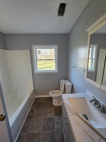 a bathroom with a toilet sink and tub