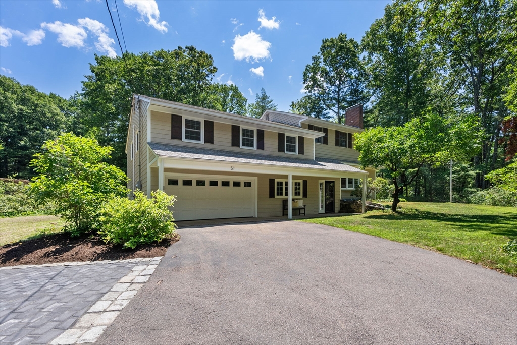 51 3 Ponds Road Wayland, MA 01778 - Photo 1 of 22 a front view of a house with a yard and potted plants