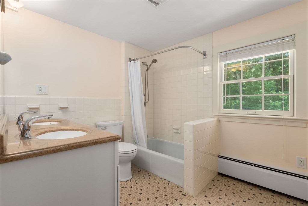 51 3 Ponds Road Wayland, MA 01778 - Photo 17 of 22 a bathroom with a sink a toilet and shower