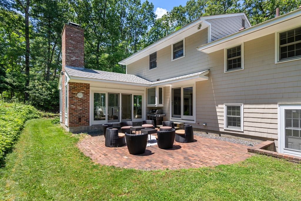 51 3 Ponds Road Wayland, MA 01778 - Photo 19 of 22 a view of a house with backyard sitting area and garden