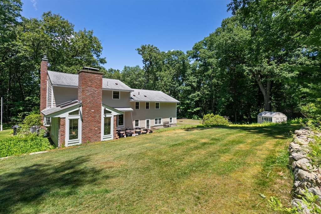 51 3 Ponds Road Wayland, MA 01778 - Photo 21 of 22 a front view of house with yard and trees