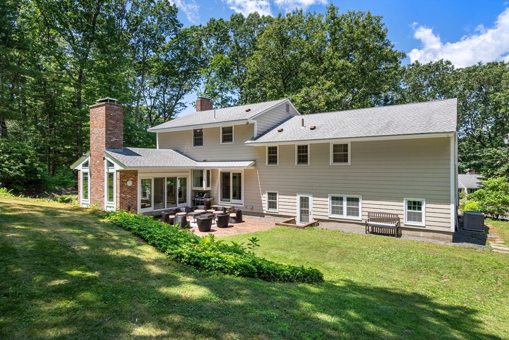 51 3 Ponds Road Wayland, MA 01778 - Photo 22 of 22 a front view of a house with garden