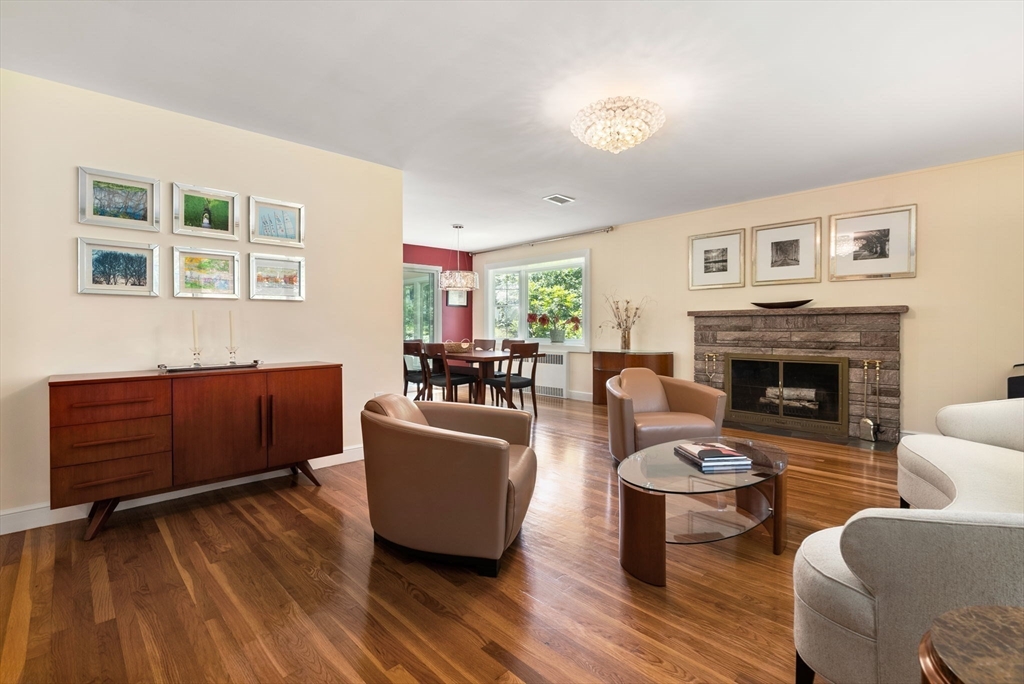51 3 Ponds Road Wayland, MA 01778 - Photo 3 of 22 a living room with furniture and a fireplace