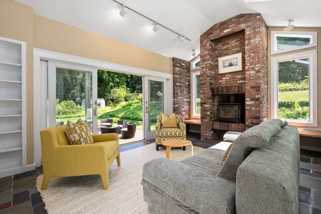 51 3 Ponds Road Wayland, MA 01778 - Photo 5 of 22 a living room with fireplace furniture and a large window