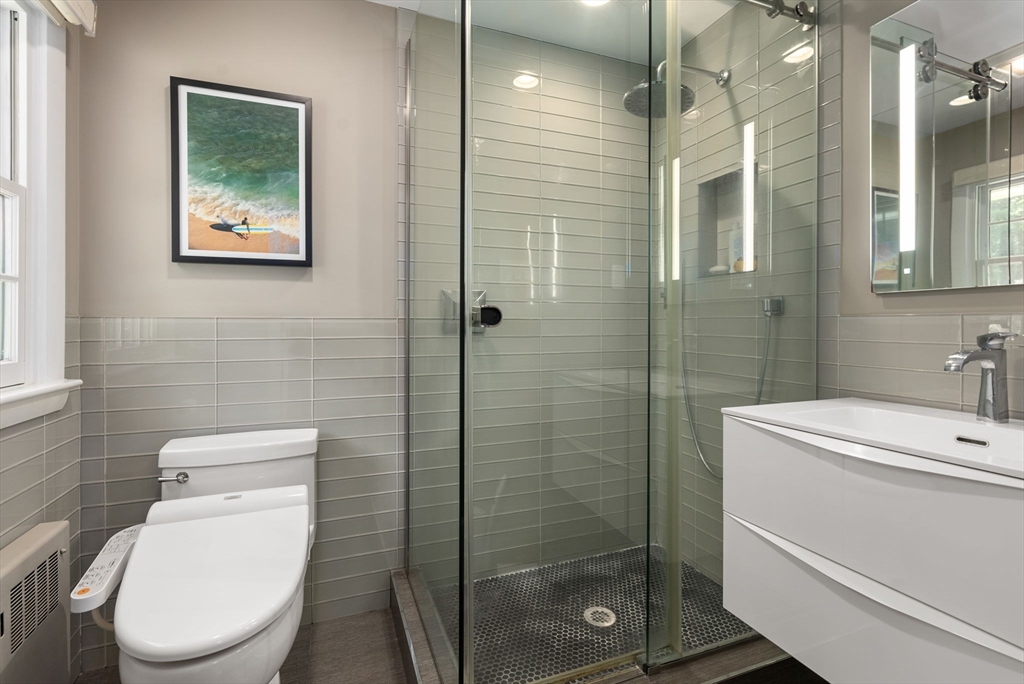 51 3 Ponds Road Wayland, MA 01778 - Photo 9 of 22 a bathroom with a toilet sink and shower