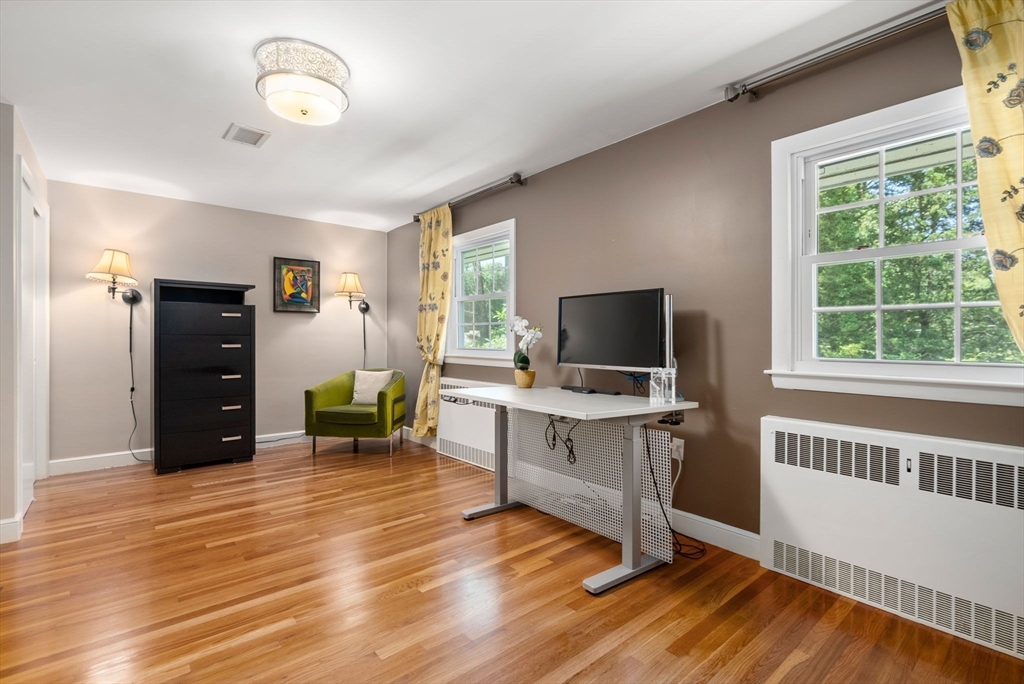 51 3 Ponds Road Wayland, MA 01778 - Photo 10 of 22 a view of a workspace with furniture and a window