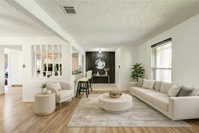 a living room with furniture and wooden floor