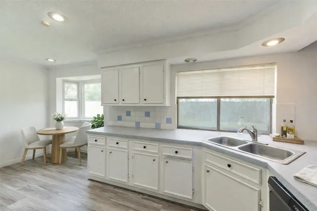 a kitchen that has a sink and a stove in it