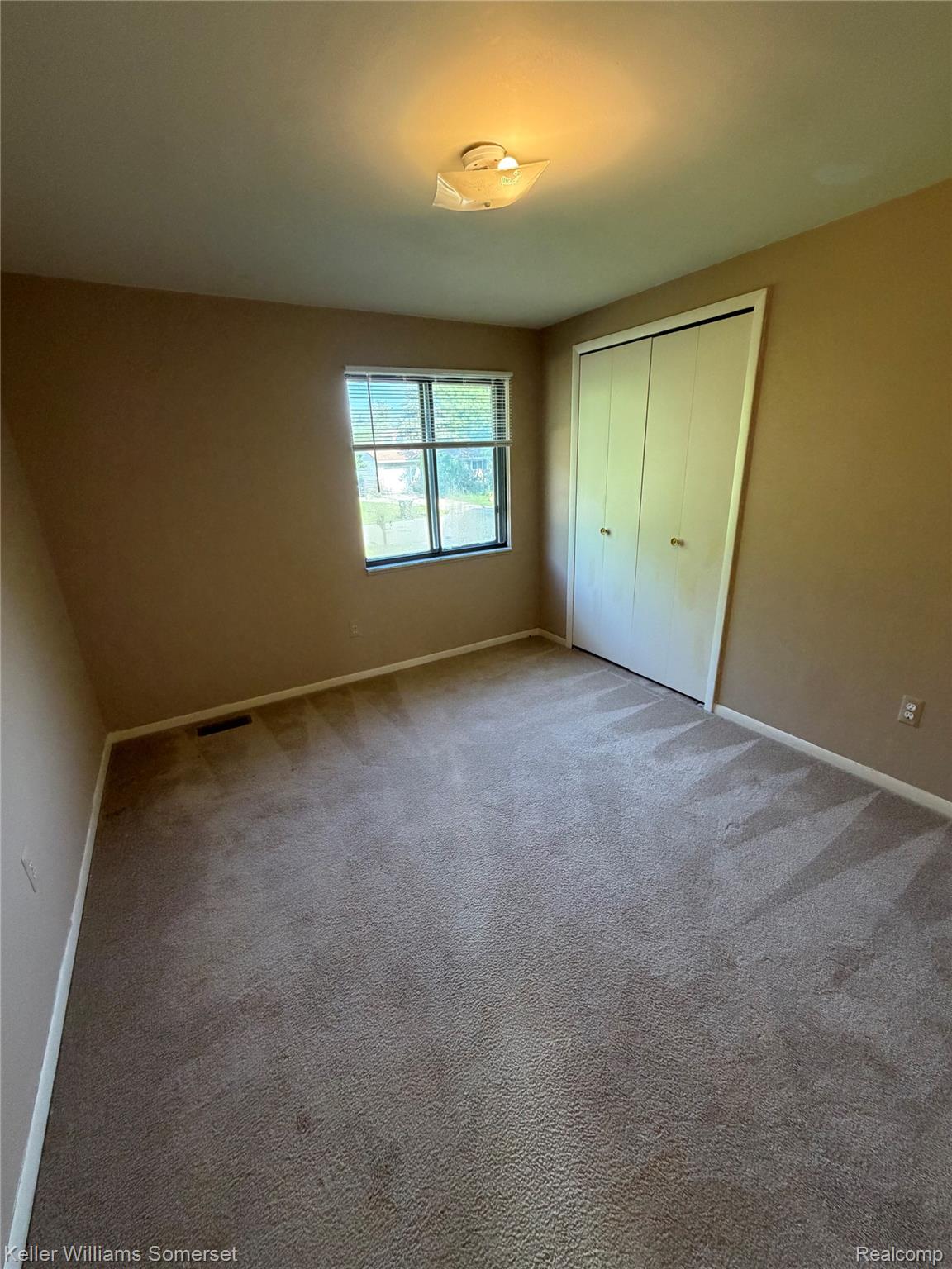 3277 Eastern Avenue Rochester, MI 48307 - Photo 8 of 13 Carpeted room with a double window, overhead flush-mount lighting, and a bi-fold closet